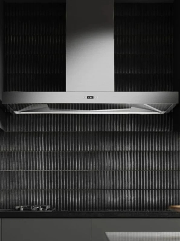 Stainless steel Westin cooker hood mounted above a sleek black tiled backsplash and minimalist kitchen countertop with built-in hob