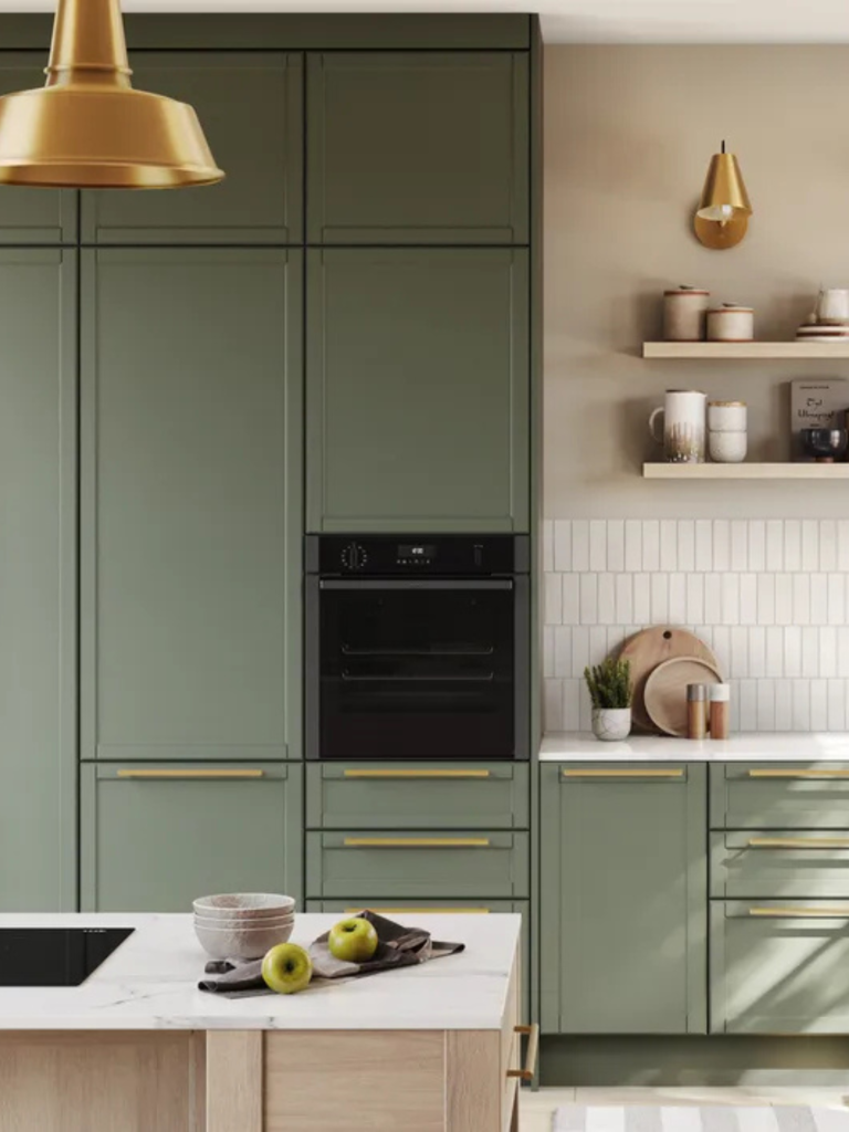Contemporary kitchen with sage green cabinets, brass handles, and a built-in black Siemens oven, styled with minimalist décor and neutral tones